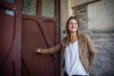 Andrea walking through the front door of the castle